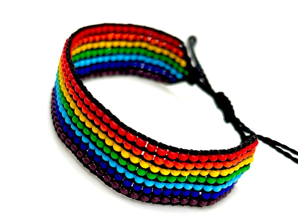 Rainbow striped beaded bracelet made with premium glass beads and black cord. Handcrafted accessory from Guatemala.