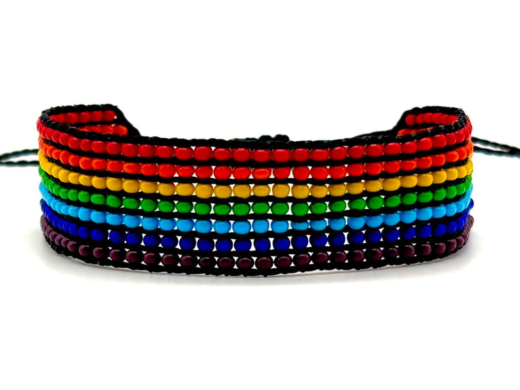 Rainbow beaded bracelet with red, orange, yellow, green, blue, and purple rows, handcrafted with premium glass beads.